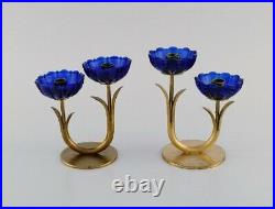 Gunnar Ander for Ystad Metall. Two candlesticks in brass and blue art glass