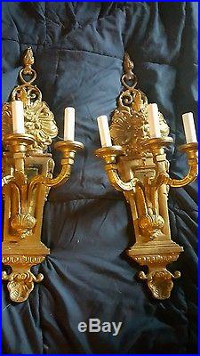 Pair of heavy brass sconces candelabras Northwind face