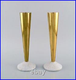 Tom Dixon, British designer. A pair of candlesticks in brass and marble
