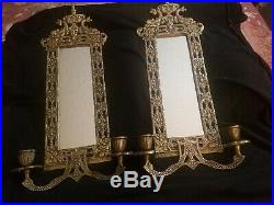 Two Antique Brass over cast iron mirrored candle sconces with dolphins
