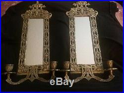 Two Antique Brass over cast iron mirrored candle sconces with dolphins